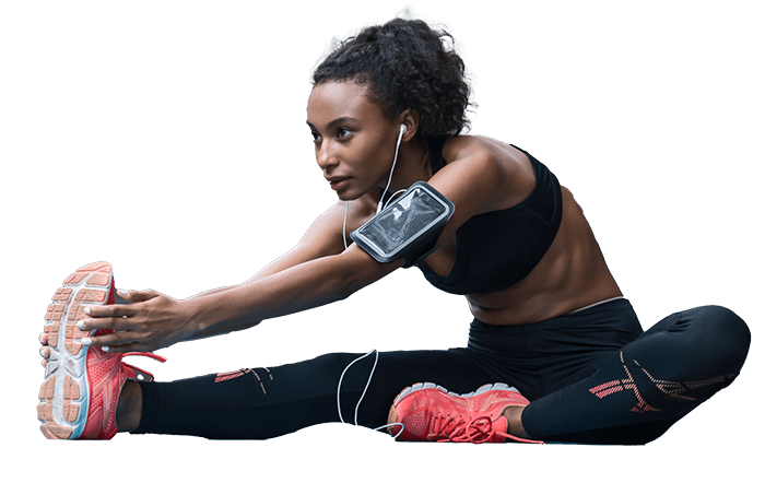 Woman stretching before workout in Congleton gym listening to music