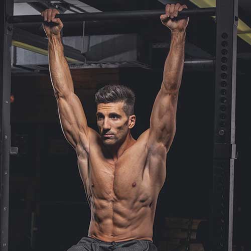 Man performing pull-up exercise in Congleton gym for upper body strength