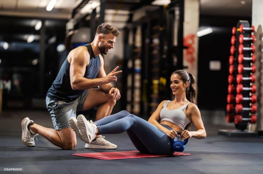 Personal trainer guiding client through core workout in Congleton gym