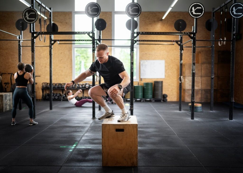 Man performing box jump exercise in Congleton gym for functional training
