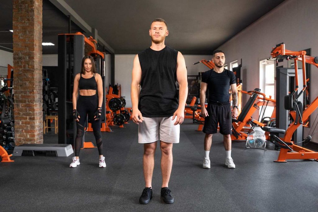 Personal trainer leading group session in Congleton gym with members standing ready