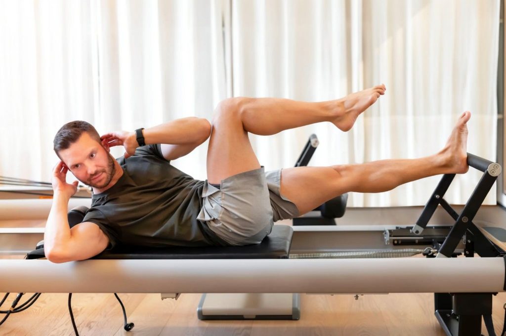 Man doing Pilates leg exercise in Congleton gym for core strength